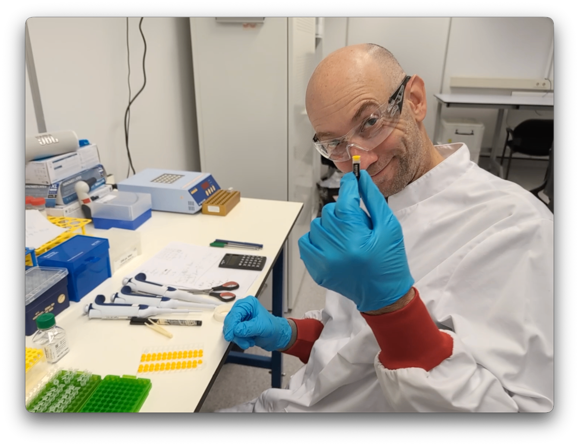 Lorenzo Bombardelli at the TIDE Genetics lab bench inspecting a sample tube.